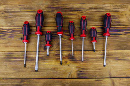 Set of screwdrivers on wooden background. Top viewの写真素材