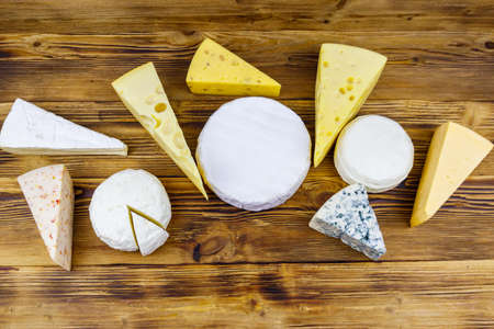 Set of various types of cheese on wooden table. Top viewの写真素材