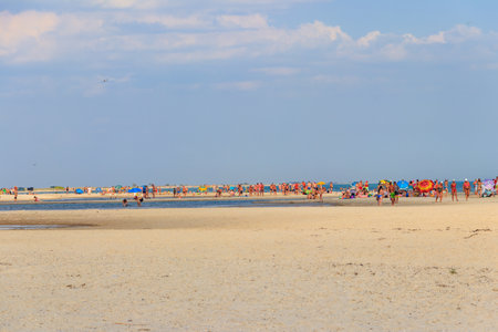 Lazurne, Ukraine - July 18, 2020: Tourists on a sandy beach of Dzharylhach island near Lazurne, Ukraineのeditorial素材