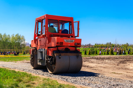 Kiev region, Ukraine - May 10, 2021: Road construction works with roller compactor machine in Dobropark park, Kiev region, Ukraineのeditorial素材