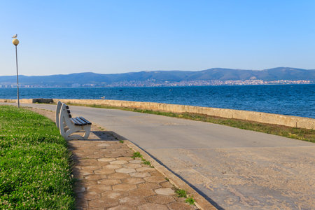 Bench on the embankment of the seaの写真素材