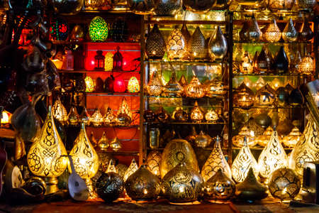 Electric luminous colorful mosaic lamps in oriental style as tourist souvenirs at night street...