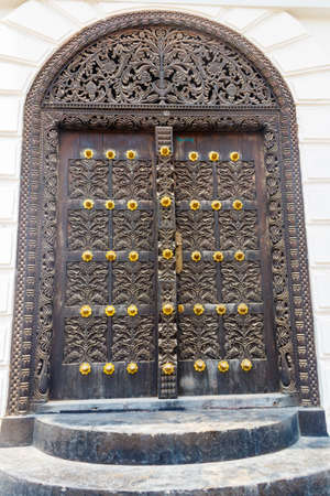 Traditional wooden carved door in Stone Town, Zanzibar, Tanzaniaの写真素材