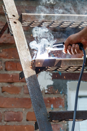 Worker welding the steel part by manual