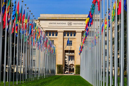 Rows of the United Nations member states flags in a front of the Palace of United Nations in Geneva, Switzerlandのeditorial素材