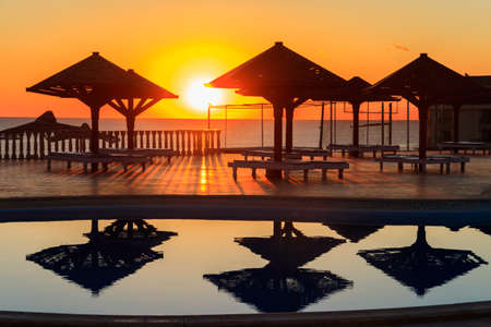 Luxury swimming pool with sea view at sunrise. Concept of rest, relaxation, holidays, resortのeditorial素材