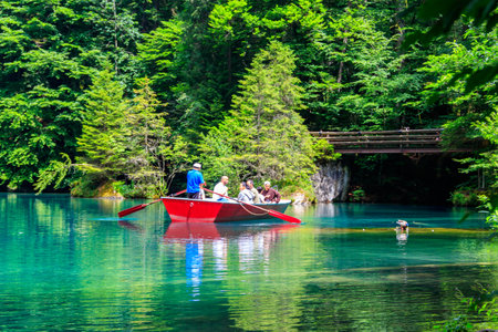 Kandergrund, Switzerland - June 21, 2022: Tourists taking a boat trip on Blausee Lake in Switzerlandのeditorial素材