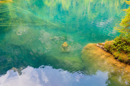 Underwater statue of young girl in Blausee lake (Blue Lake) in Bernese Oberland, Kandergrund,...