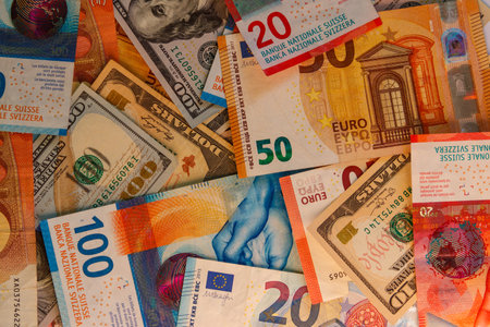 Multicurrency background of US dollars, euros and Swiss francsの写真素材