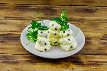 Christmas salad in the shape of snowmen and Christmas tree on a plate on wooden tableの写真素材