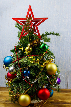 Small decorated Christmas tree on a table in a roomの写真素材
