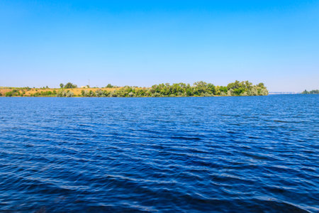 Summer landscape with beautiful river, green trees and blue sky