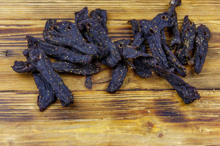 Slices of biltong (South African dried meat) on wooden tableの写真素材
