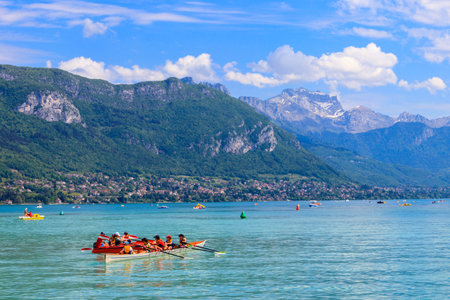 Annecy, France - May 16, 2022: Tourists kayaking at Annecy lake surrounded by beautiful mountains in Annecy, Franceのeditorial素材