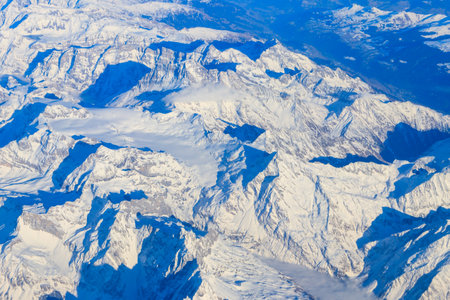 View of the Swiss Alps covered with snow from airplane
