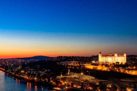 View of Bratislava castle, old town and the Danube river from deck observation the bridge in Bratislava, Slovakia at nightのeditorial素材