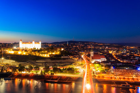 View of Bratislava castle, old town and the Danube river from deck observation the bridge in Bratislava, Slovakia at nightのeditorial素材