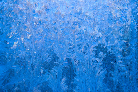 Frost pattern on a frozen window at winter. Natural background, textureの写真素材