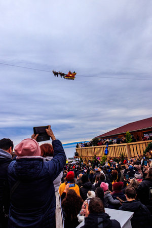 Montreux, Switzerland â November 27, 2022: Undefined people looking on flying Santa Claus during the Christmas market in Montreux, Switzerlandのeditorial素材