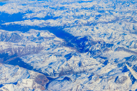 View of the Swiss Alps covered with snow from airplaneの写真素材