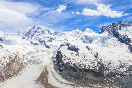 Magnificent panorama of the Pennine Alps with famous Gorner Glacier and impressive snow capped mountains Monte Rosa Massif close to Zermatt, Switzerlandの写真素材