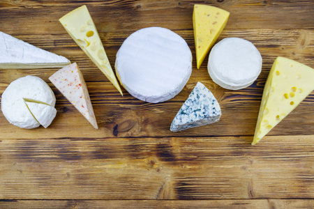 Set of various types of cheese on wooden table. Top viewの写真素材