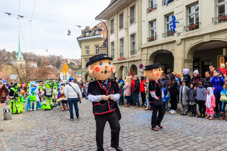 Bern, Switzerland - February 24, 2023: People marching and playing instruments during Bern carnival...