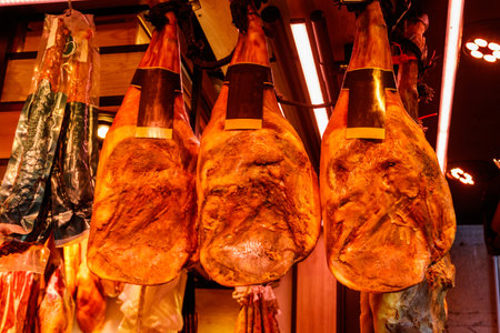Jamon serrano ham legs hanging in a traditional spanish market