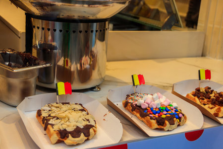 Belgian waffles with colorful sweet toppings and fruits for sale in Brussels, Belgiumの写真素材