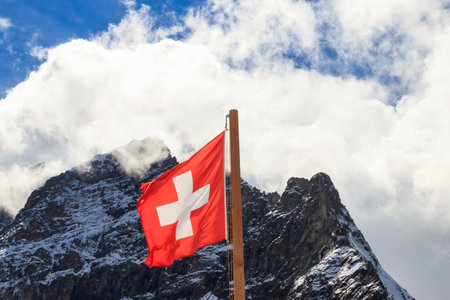 Red Swiss flag over the Swiss Alps background