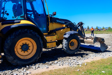 Kiev region, Ukraine - May 10, 2021: Bulldozer working on a road construction site in Dobropark...