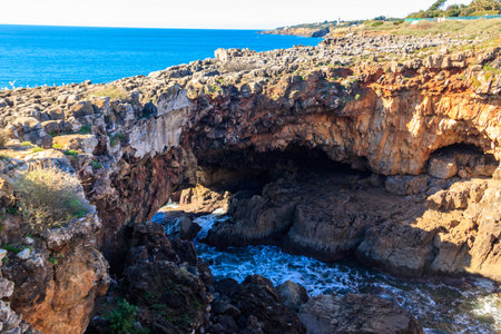 Boca do Inferno is a unique rock formation on the edge of the ocean in Cascais, Portugalの写真素材