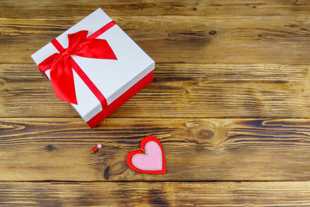 Gift box and red heart on a wooden background. Valentine's Day conceptの写真素材