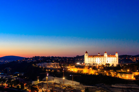 View of Bratislava castle, old town and the Danube river from observation deck the bridge in Bratislava, Slovakia at nightの写真素材