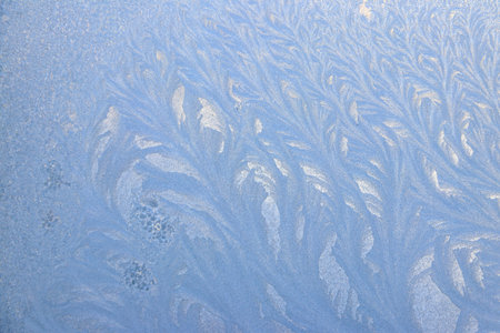 Frost pattern on a frozen window at winter. Natural background, textureの写真素材