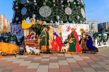 Wooden Christmas Nativity scene with Holy family in city parkの写真素材
