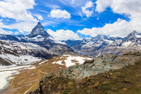 Scenic view on snowy Matterhorn mountain peak in sunny day with blue sky in Switzerland. Beautiful nature background of Swiss Alps covered with snow. Famous travel destinationの写真素材