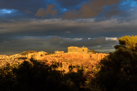 View of the Acropolis Hill, crowned with Parthenon during evening golden hour from the Philopappos Hill in Athens, Greeceの写真素材