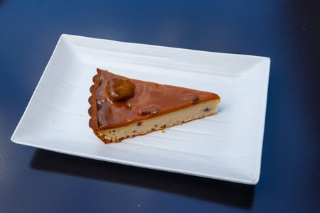 Piece of chestnut cheesecake on a tableの写真素材
