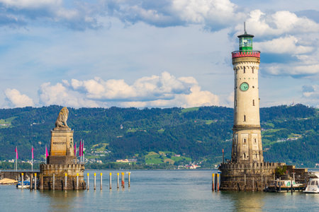 Lighthouse and Bavarian Lion at the harbor entrance in Lindau, Germany. Antique bavarian town at Lake Constance (Bodensee)の写真素材