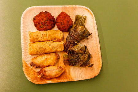 Set of thai food (fried chicken wrapped in pandan leaves, chicken wings, vegetable spring rolls,...