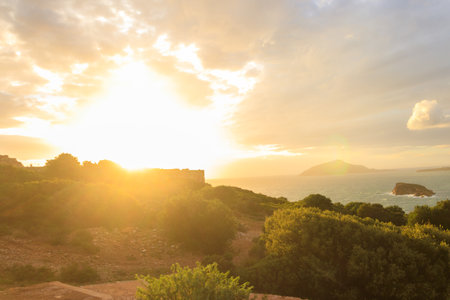Panoramic view of the bay of Cape Sounio during golden hour in Attica, Greece near the archaeological temple of Poseidonの写真素材