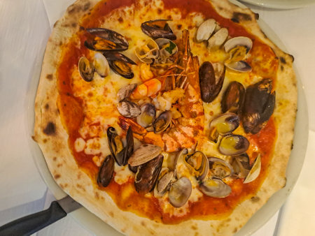 Delicious pizza with seafood in pizzeria. Top viewの写真素材