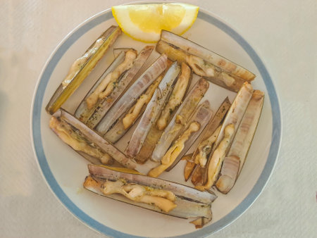 Delicious razor clams on a plate in restaurantの写真素材