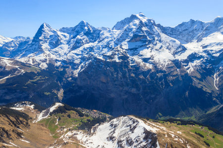 View of three famous Swiss mountain peaks Eiger, Monch and Jungfrau in the Bernese Oberland in Switzerlandの写真素材