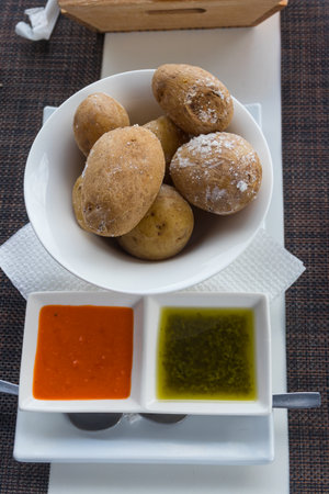 Portion of canarian potatoes (papas arrugadas) with red and green mojo sauce. Typical dish of the Canary Islandsの写真素材