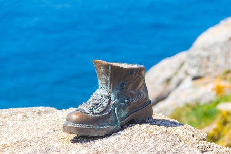 The boot of Cape Finisterre in Galicia, Spain. The bronze boot marks the end of Saint James Wayの写真素材