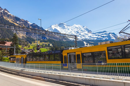 Tourist train at the station in alpine Wengen village in Bernese Oberland, Switzerlandの写真素材