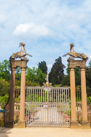 Entrance of the Isolotto in Boboli Gardens, Florence, Italy. An iron gate, large columns with Capricorn statues on topの写真素材