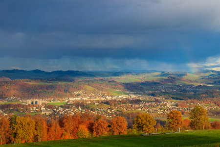 Autumn view of Bern suburbs and yellow deciduous forest from Gurten mountain in Switzerlandの写真素材